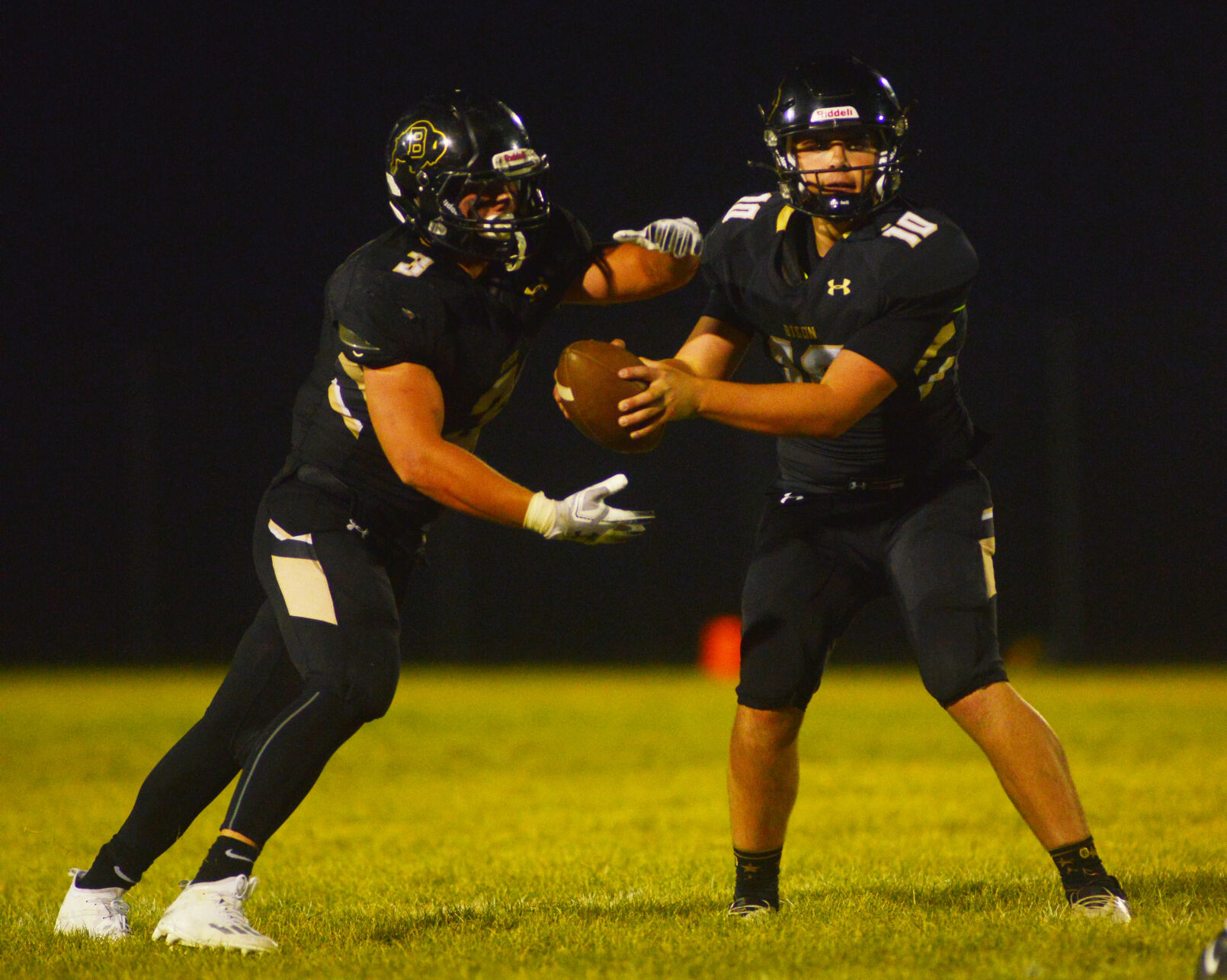 Jackson Moon fakes a hand off to senior Hyrum Hatch before throwing